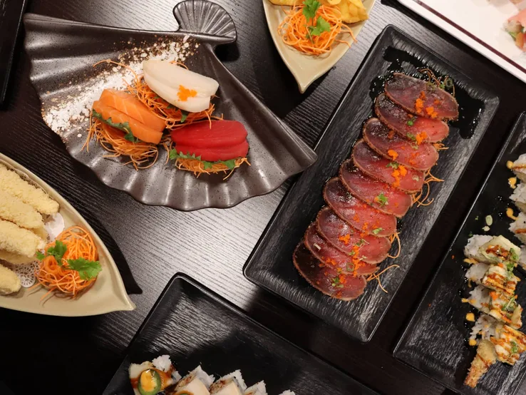Assorted sushi rolls, sashimi and tempura spread